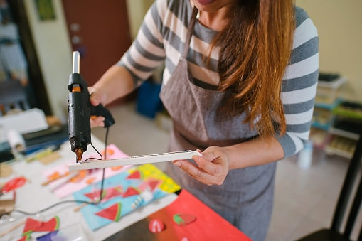 hot glue stick being applied to crafts